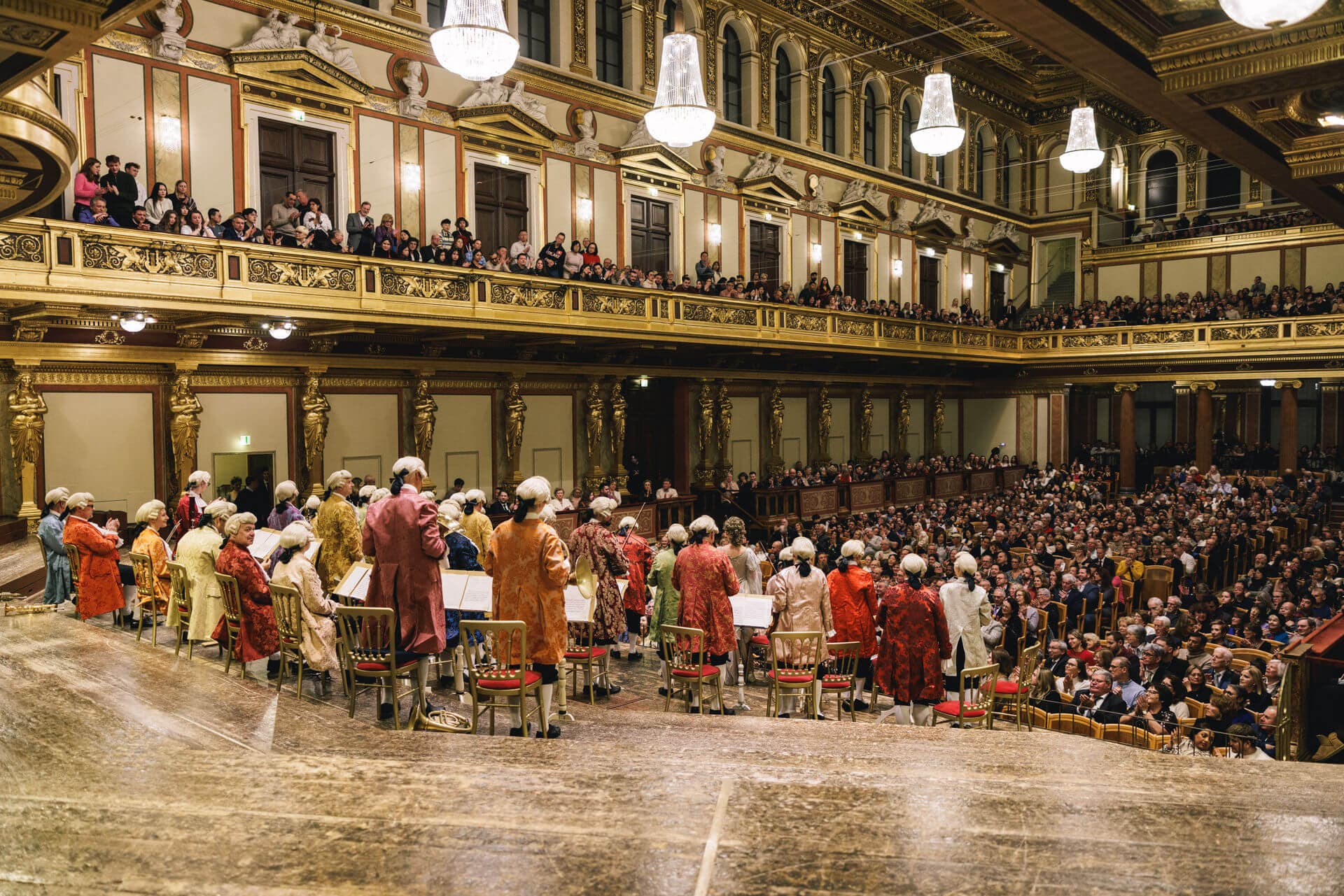 The Vienna Mozart Orchestra in historical costumes performing in the gilded Golden Hall of the Vienna Musikverein